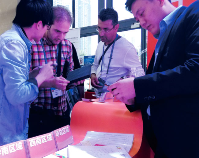 广州琶洲国际会展中心B区钱柜QG777工作人员与前来参观朋友交谈